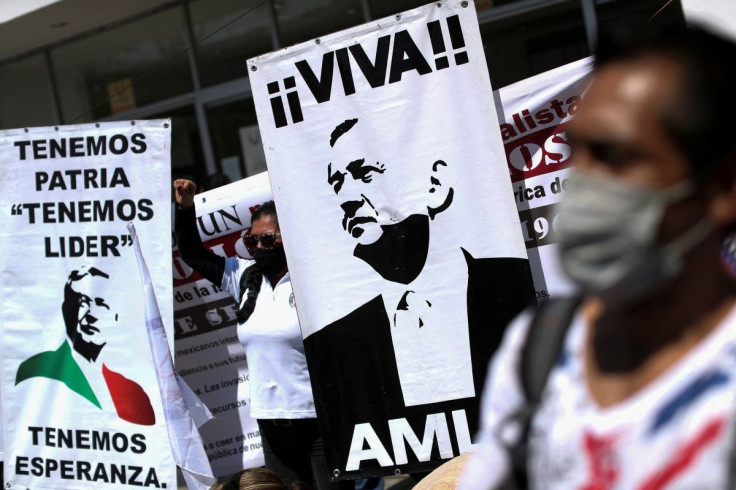 A demonstrator gestures in support of Mexico's President Andres Manuel Lopez Obrador and his plan to boost state control of the power market during a demonstration outside National Congress in Mexico City, Mexico, February 17, 2022. 