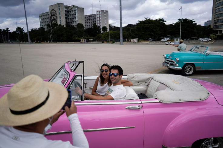 Tourists from Spain have their pictures taken at the Revolution square in Havana, Cuba, November 23, 2021. Picture taken on November 23, 2021.