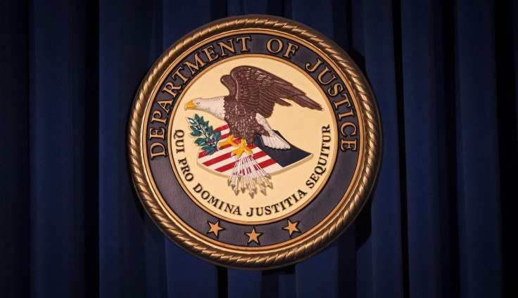 The Department of Justice (DOJ) logo is pictured on a wall after a news conference to discuss alleged fraud by Russian Diplomats in New York December 5, 2013. 