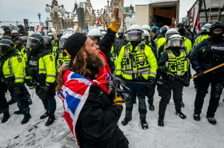 A demonstrator in front of a police line on February 19, 2022 in Ottawa