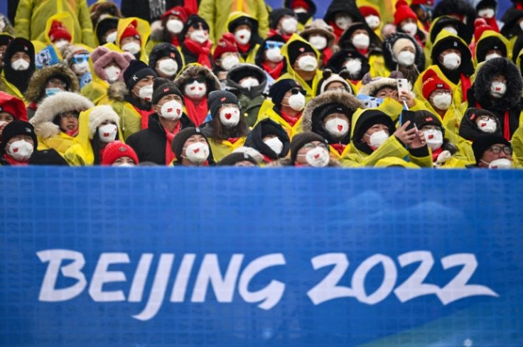 Spectators watch athletes compete in the freestyle skiing in Beijing