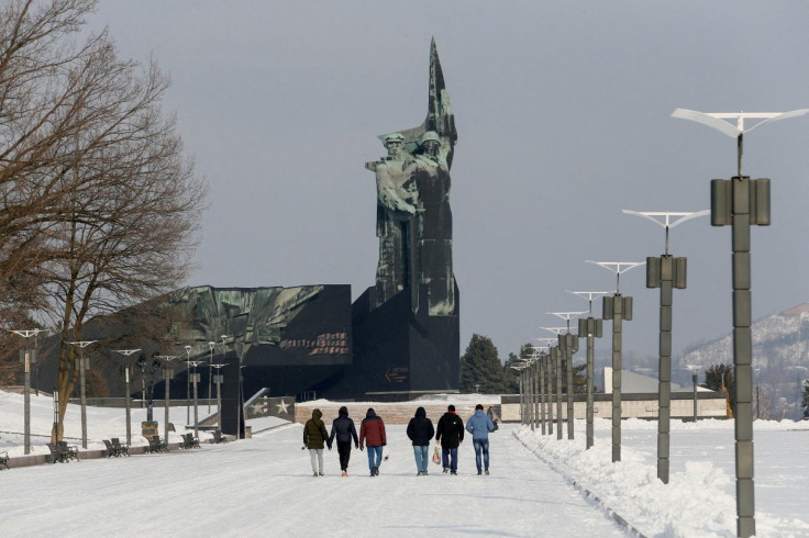 People walk towards a monument to the Liberators of Donbass in the rebel-held city of Donetsk, Ukraine January 27, 2022.