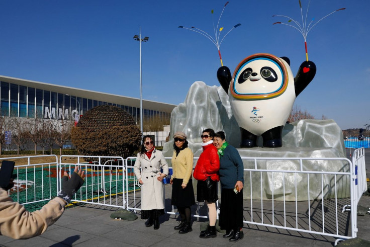 People pose for pictures near an installation of the Beijing 2022 Olympics mascot Bing Dwen Dwen, ahead of the closing ceremony of the Beijing 2022 Winter Olympics, in Beijing, China February 20, 2022. 