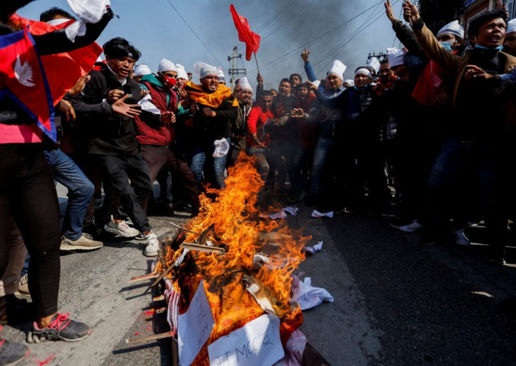 Protesters cremate a dummy corpse representing a U.S infrastructure grant before cremating it during a protest against the $500 million U.S infrastructure grant under the Millennium Challenge Corporation (MCC) near the parliament in Kathmandu, Nepal Febru