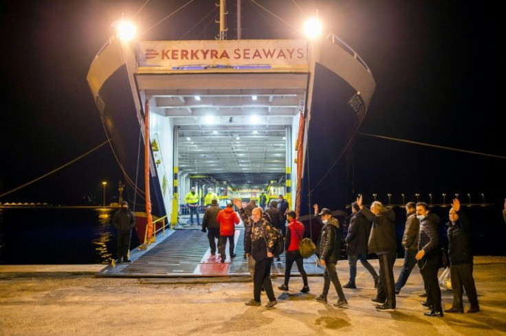 Turkish survivors board another ferry on their way home from Corfu