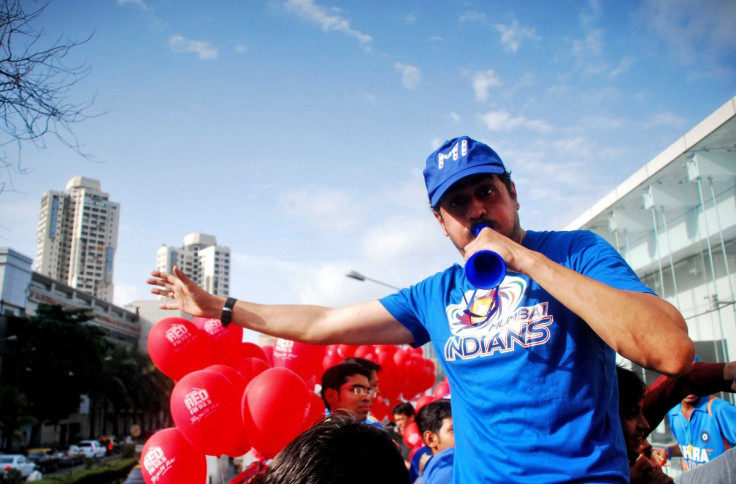 A Mumbai Indians' fan blows a horn as he arrives to watch the Indian Premier League (IPL) cricket match between the Mumbai Indians' and Deccan Chargers at a stadium in Mumbai May 14, 2011.