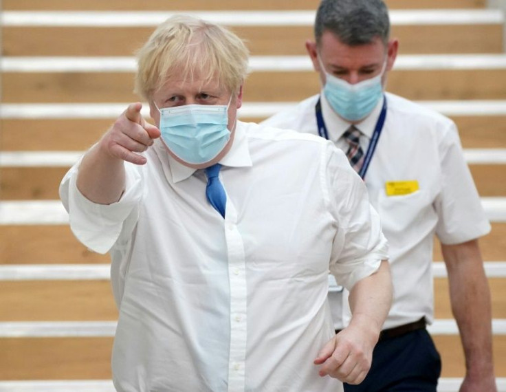 Britain's Prime Minister Boris Johnson is set this week to end all legal pandemic restrictions, but denies throwing "caution to the wind"