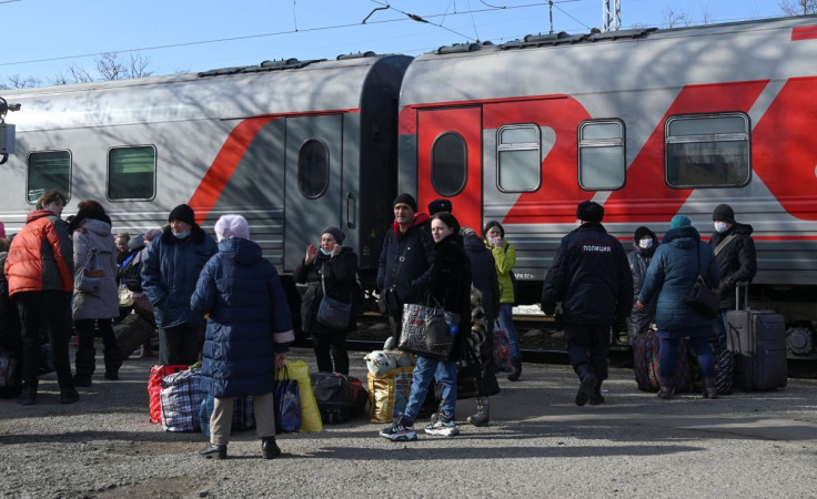 People, who were evacuated from separatist-controlled regions in eastern Ukraine, board a train before leaving the city of Taganrog in the Rostov region, Russia February 20, 2022. 