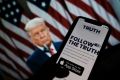 Donald Trump's new 'Truth Social' app is seen on a smartphone screen before a picture of the former president
