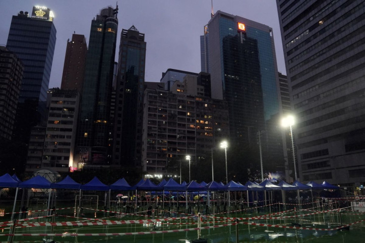 People queue at dusk at a makeshift testing centre for the coronavirus disease (COVID-19) in Hong Kong, China February 20, 2022. 