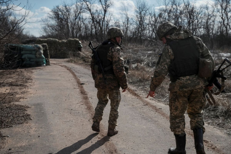 Ukrainian service members walk near the front line near the city of Novoluhanske in the Donetsk region, Ukraine February 20, 2022. 