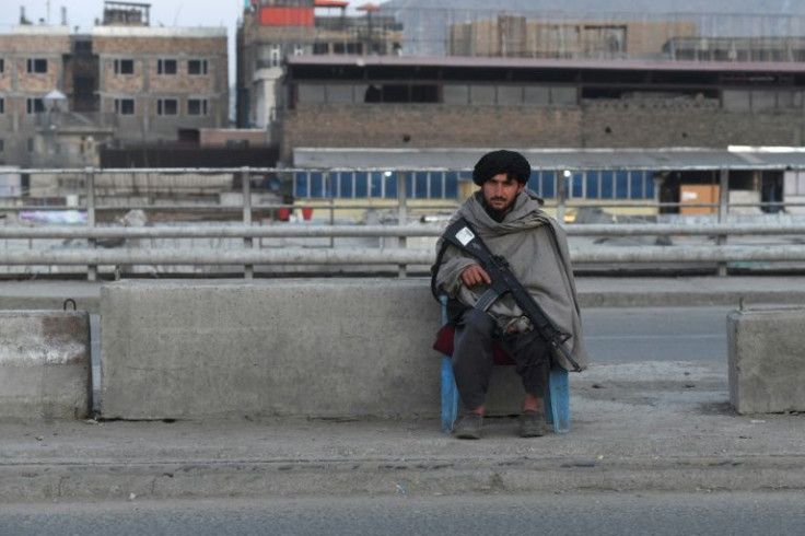 A Taliban fighter guards a checkpost on a Kabul road
