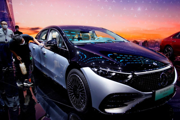 A staff member cleans a Mercedes-Benz EQS 580 4MATIC electric vehicle during a media day for the Auto Shanghai show in Shanghai, China April 19, 2021.