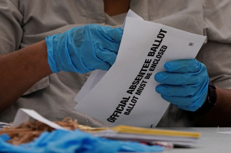A DeKalb County election worker opens absentee ballot envelopes following the U.S. Senate runoff elections in Decatur, Georgia, U.S., January 6, 2021.