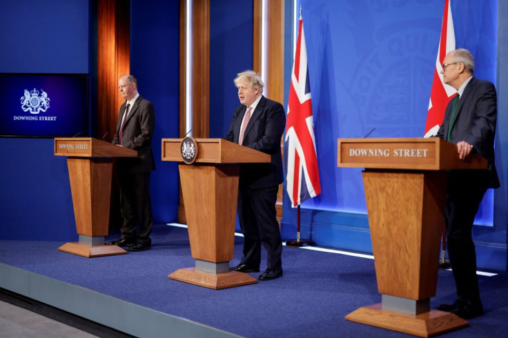 Britain's Chief Medical Officer for England Chris Whitty, Prime Minister Boris Johnson, and Chief Scientific Adviser Patrick Vallance attend a news conference to outline the government's new long-term coronavirus disease (COVID-19) pandemic plan, at Downi