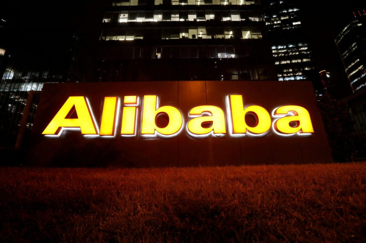 The logo of Alibaba Group is lit up at its office building in Beijing, China August 9, 2021. 