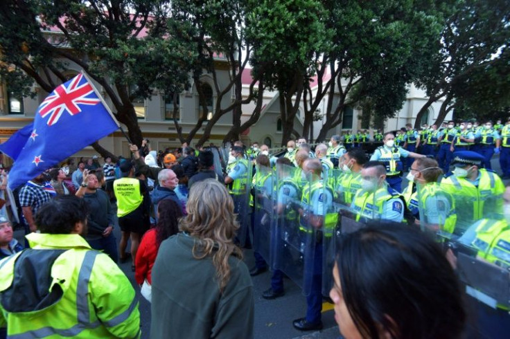 Police hold riot shields as demonstrators against Covid-19 vaccine mandates and restrictions gather outside of the New Zealand Parliament grounds in Wellington, New Zealand, on February 22, 2022