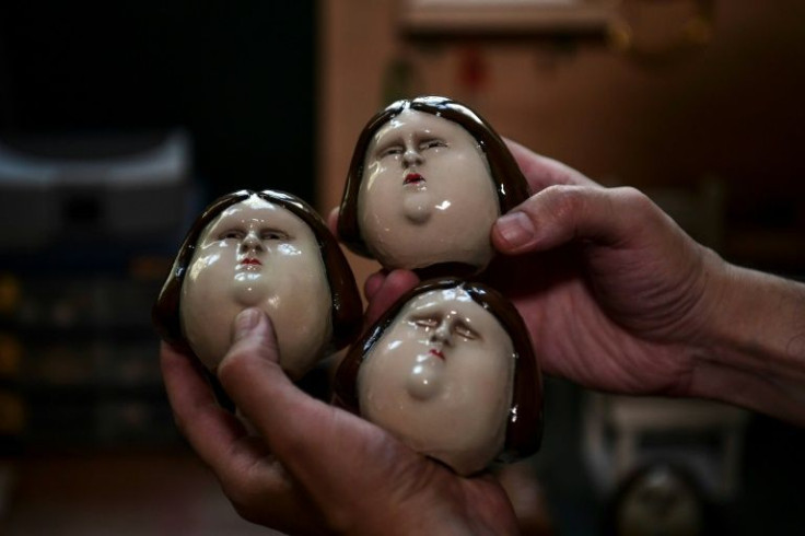 Ingrid Olderock, here depicted as a doll with different expressions, trained dogs to sexually assault women prisoners in Chile