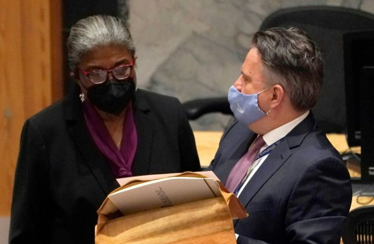 Ukraine's UN representative Sergiy Kyslytsya (R) talks with US ambassador to the UN Linda Thomas-Greenfield during an emergency Security Council meeting on the Ukraine crisis, in New York