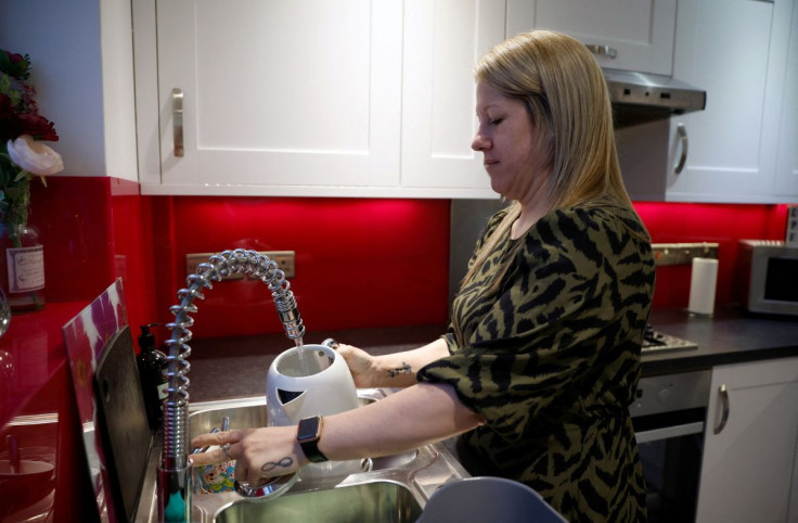 Care worker Nicola Frape fills a kettle in the kitchen of her home in Ashford, Kent, Britain February 17, 2022. Picture taken February 17, 2022.