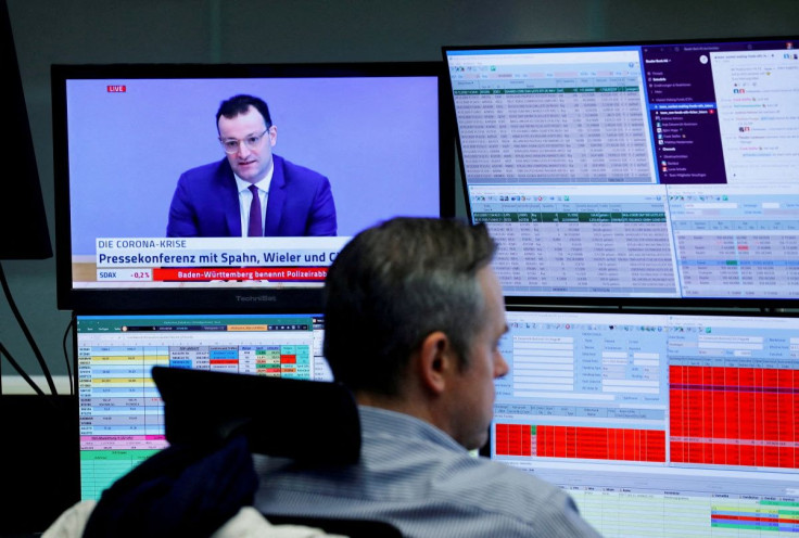 A trader sits in front of a television broadcast showing German Health Minister Jens Spahn during a trading session at the Frankfurt's stock exchange, amid the coronavirus disease (COVID-19) outbreak, in Frankfurt, Germany, December 30, 2020. 