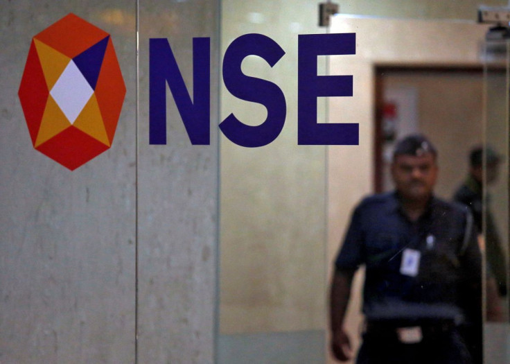 A security guard walks past the logo of the National Stock Exchange (NSE) inside its building in Mumbai, India, May 28, 2019. 