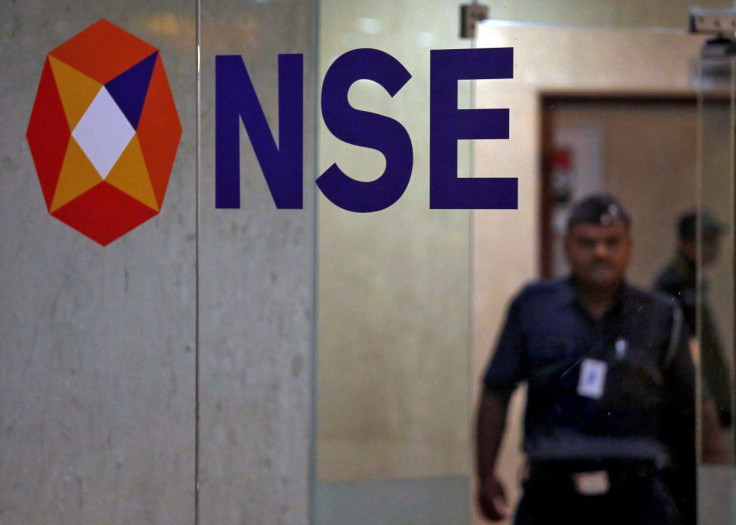 A security guard walks past the logo of the National Stock Exchange (NSE) inside its building in Mumbai, India, May 28, 2019.