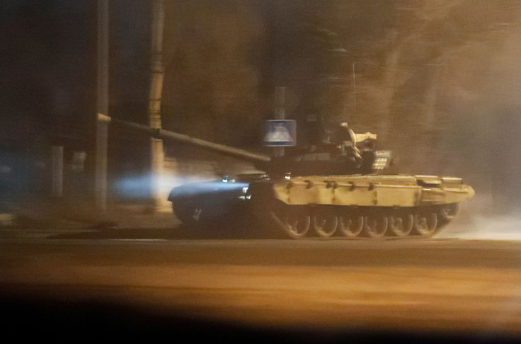 A tank drives along a street after Russian President Vladimir Putin ordered the deployment of Russian troops to two breakaway regions in eastern Ukraine following the recognition of their independence, in the separatist-controlled city of Donetsk, Ukraine