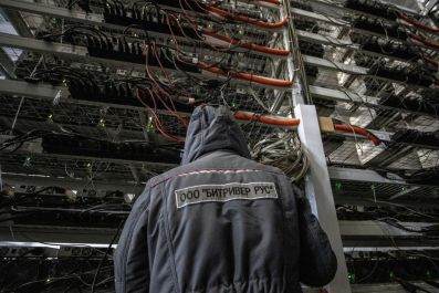 An employee works at the data centre of BitRiver company providing services for cryptocurrency mining in the city of Bratsk in Irkutsk Region, Russia March 2, 2021. BitRiver offers hosting services and turnkey solutions for cryptocurrency mining operation