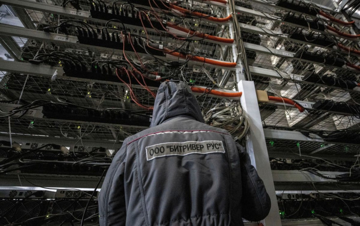 An employee works at the data centre of BitRiver company providing services for cryptocurrency mining in the city of Bratsk in Irkutsk Region, Russia March 2, 2021. BitRiver offers hosting services and turnkey solutions for cryptocurrency mining operation