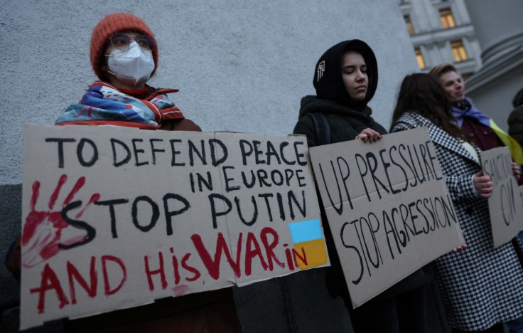 Activists hold banners in front the Ukrainian Foreign Ministry as they demand European Union to improve additional sanctions against Russia, in central Kyiv, Ukraine February 21, 2022.