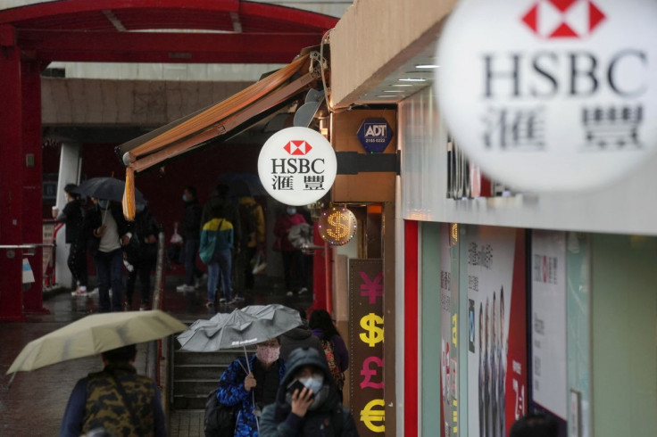 Pedestrians wearing face masks following the coronavirus disease (COVID-19) outbreak, walk past a HSBC bank branch in Hong Kong, China February 22, 2022.