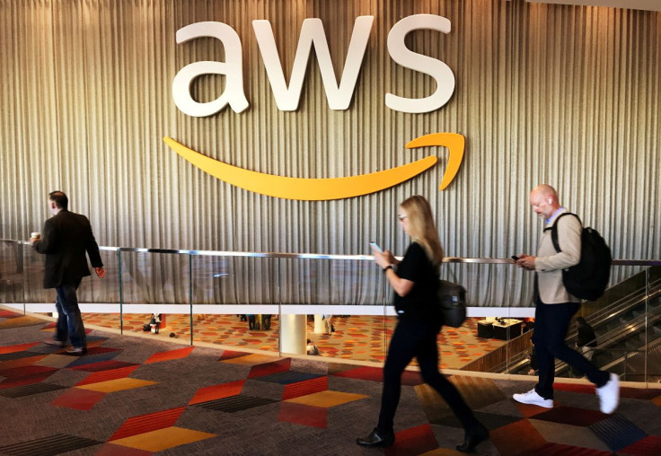 Attendees at Amazon.com Inc annual cloud computing conference walk past the Amazon Web Services logo in Las Vegas, Nevada, U.S., November 30, 2017.  