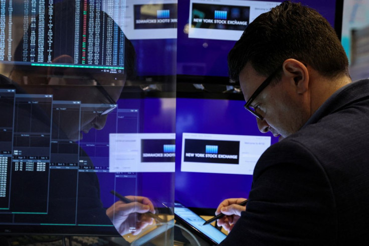 FILE PHOTO - A trader works on the floor of the New York Stock Exchange (NYSE) in New York City, U.S., February 18, 2022.  