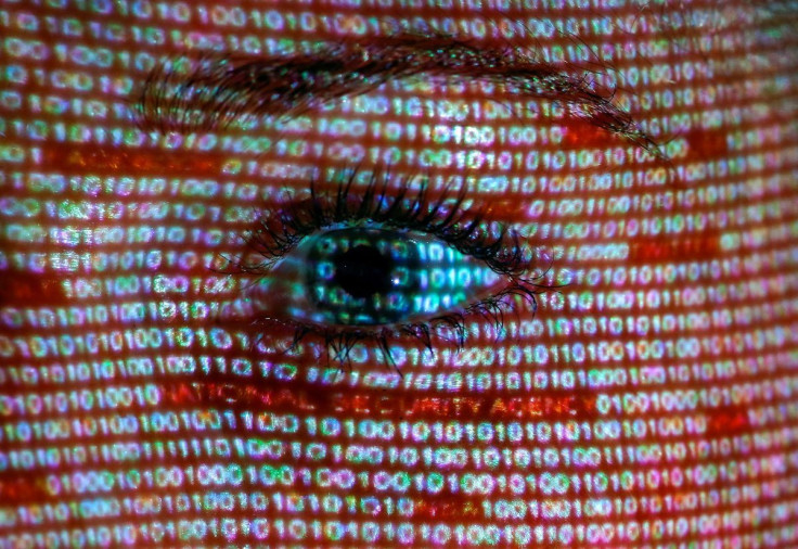 An illustration picture shows a projection of text on the face of a woman in Berlin, June 12, 2013.