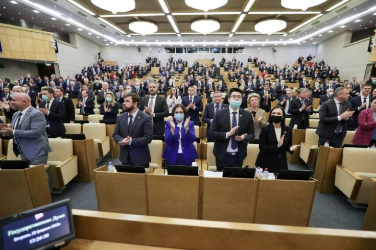 Members of the Duma, Russia's lower house of parliament, applaud after voting to ratify President Vladimir Putin's agreements with east Ukraine's separatist republics