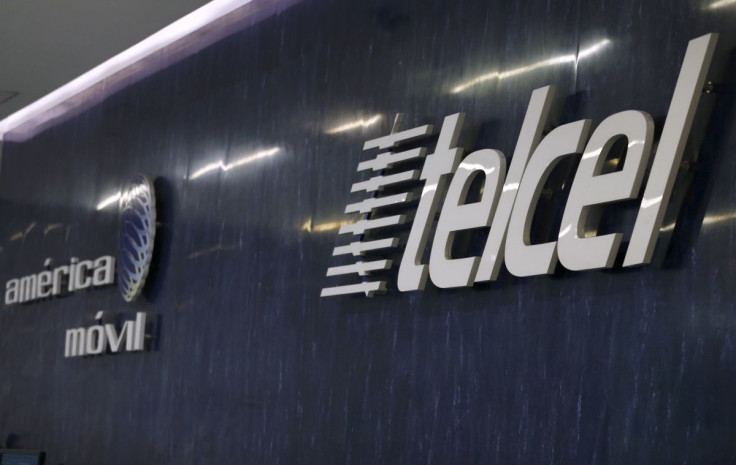 The logos of America Movil and its commercial brand Telcel are seen on the wall of the reception area in the company's corporate offices in Mexico City August 12, 2015.