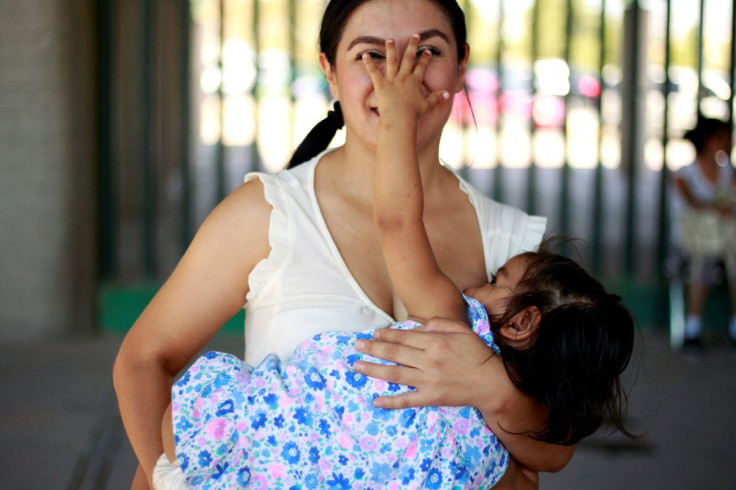 A mother reacts as she nurses her child to mark the World Breastfeeding Week to promote global support for breastfeeding in Ciudad Juarez, Mexico August 4, 2018. 