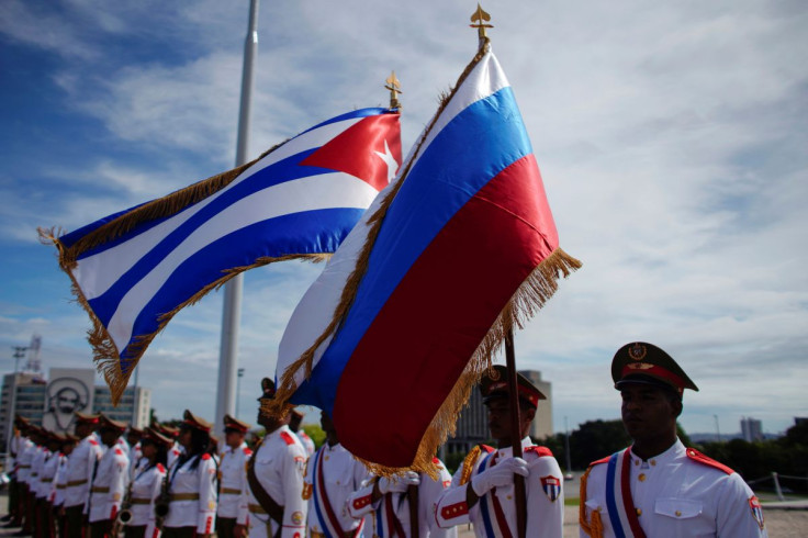 Honor guards hold a Russian and a Cuban flag during a wreath-laying ceremony with Russia's Prime Minister Dmitry Medvedev (not pictured) at the Jose Marti monument in Havana, Cuba, October 3, 2019.