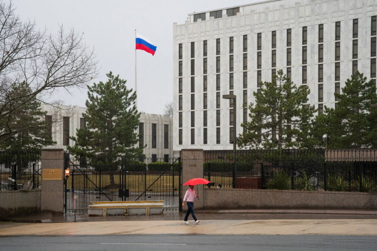 A pedestrian walks with an umbrella outside the Embassy of the Russian Federation, near the Glover Park neighborhood of Washington, U.S., February 22, 2022. 