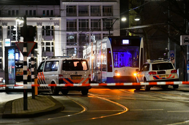 Police vehicles are seen near an Apple store in central Amsterdam during a hostage incident in the store, in Amsterdam, Netherlands February 22, 2022. 