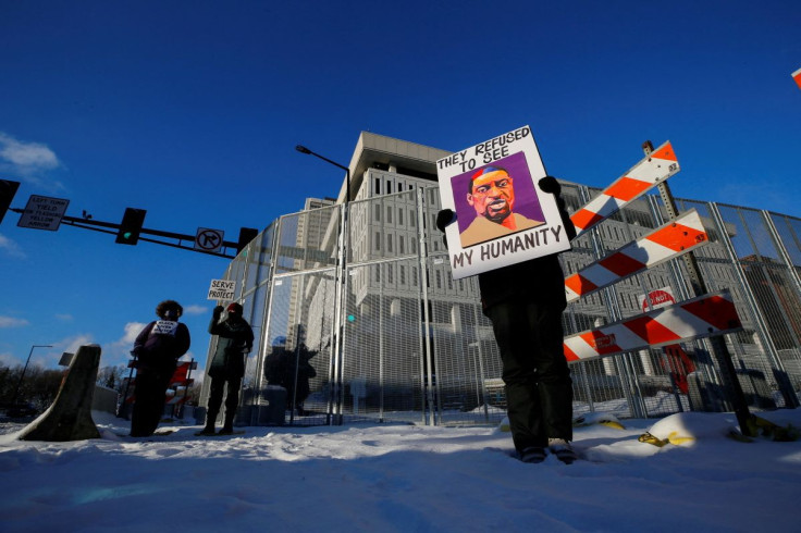 Protestors stand outside of the Warren E. Burger Federal Building and U.S. Courthouse before opening arguments of the civil trial of three former Minneapolis police officers, Tou Thao, J. Alexander Kueng and Thomas Lane, charged with violating George Floy