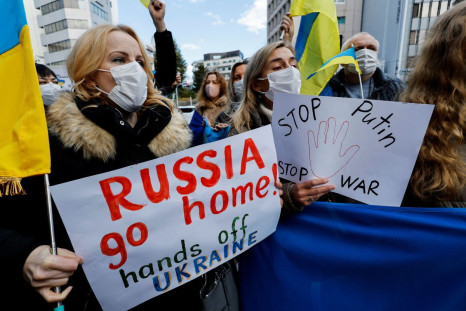 Ukrainians residing in Japan hold placards and flags during a protest rally denouncing on Russia over its actions in Ukraine, near Russian embassy in Tokyo, Japan February 23, 2022.  