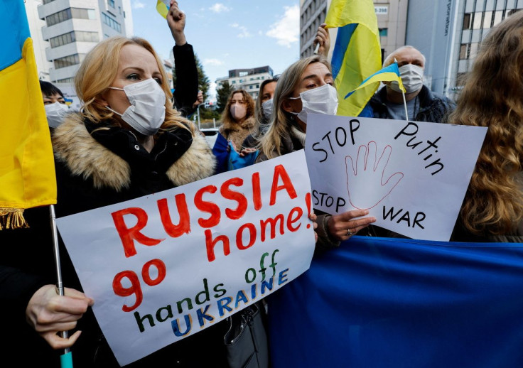 Ukrainians residing in Japan hold placards and flags during a protest rally denouncing on Russia over its actions in Ukraine, near Russian embassy in Tokyo, Japan February 23, 2022.  