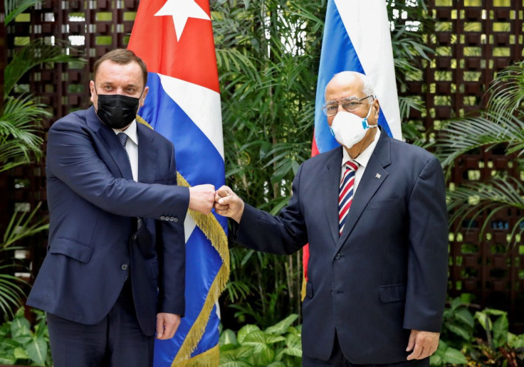 Russia's Deputy Prime Minister Yuri Borisov (L) and his Cuban counterpart Ricardo Cabrisas pose for photos in Havana, Cuba, March 31, 2021. Ernesto Mastrascusa/ Pool via