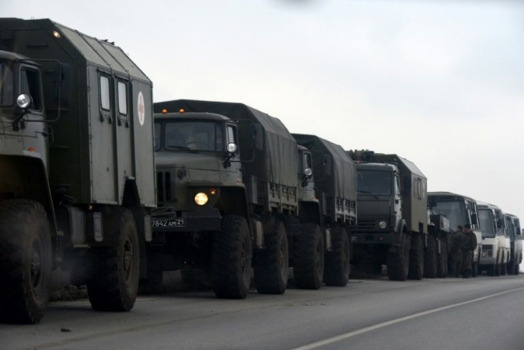 Russian military trucks are parked near the border with the self-proclaimed Donetsk People's Republic
