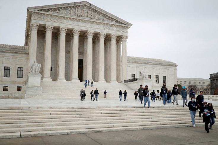 A visiting school group walks along the plaza at the U.S. Supreme Court on Capitol Hill in Washington, U.S., February 22, 2022. 