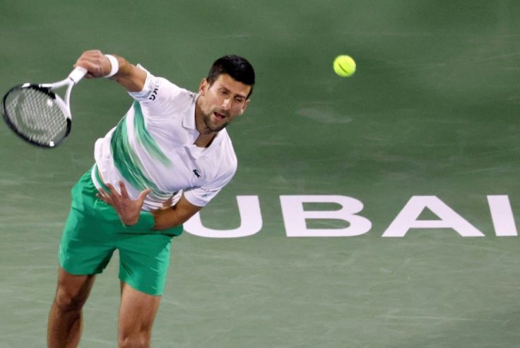 Moving on: Novak Djokovic returns the ball to Karen Khachanov on Wednesday