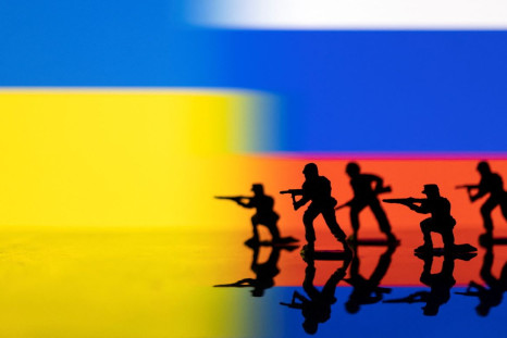 Army soldier figurines are displayed in front of the Ukrainian and Russian flag colours background in this illustration taken, February 13, 2022. 