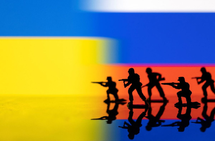 Army soldier figurines are displayed in front of the Ukrainian and Russian flag colours background in this illustration taken, February 13, 2022. 